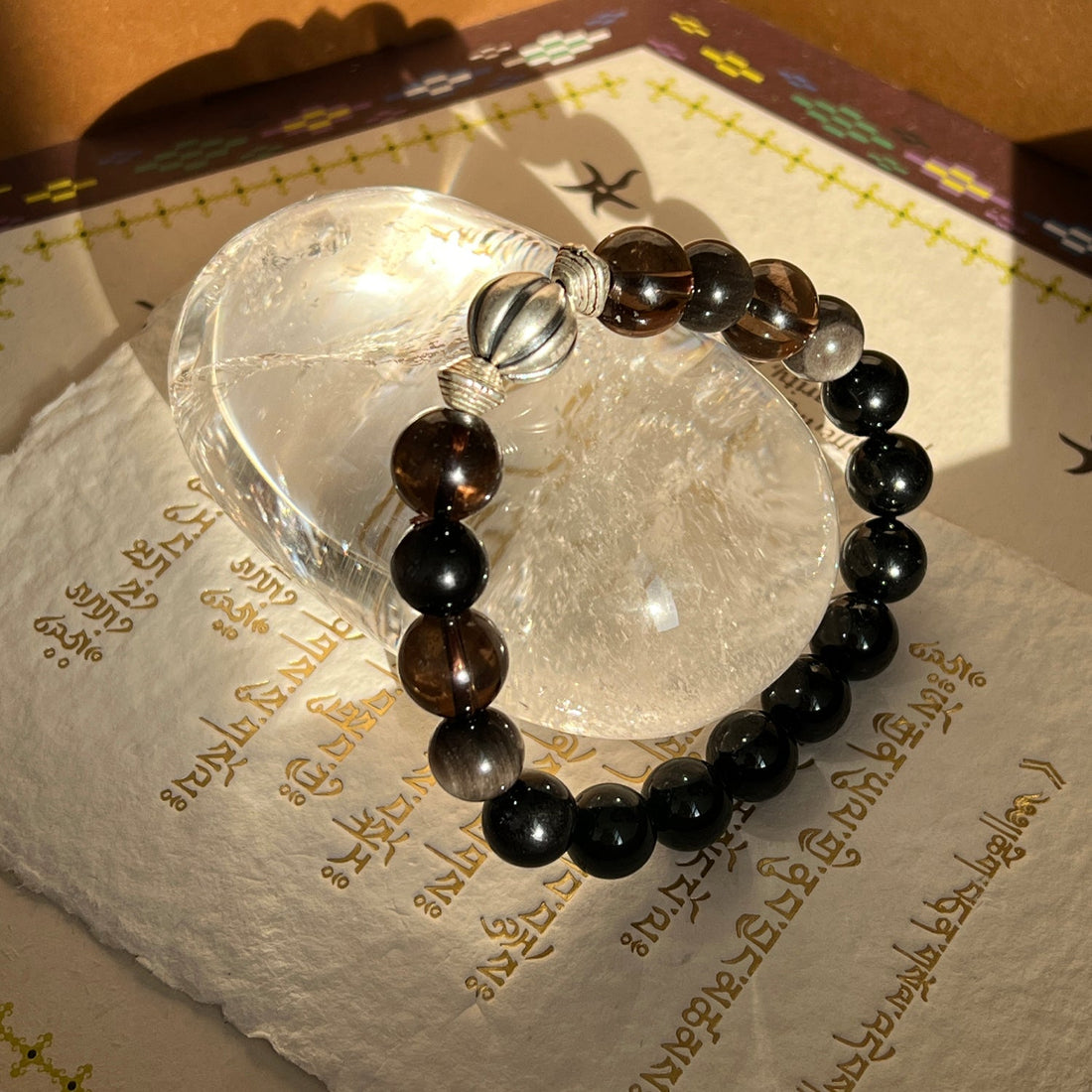 tibetan bracelet of fortune displayed on colorful textiles
